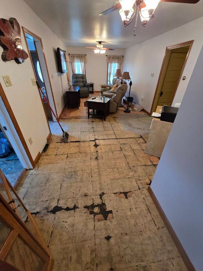 Living room with exposed subfloor during preparation