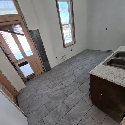 Large gray tile flooring in a remodeling project